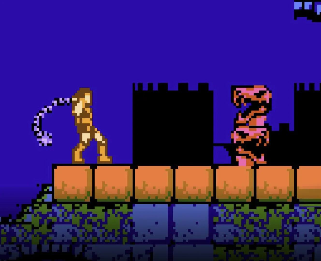 Simon Belmont estala o chicote em cima de uma muralha de tijolos, com um monstro rosa à direita